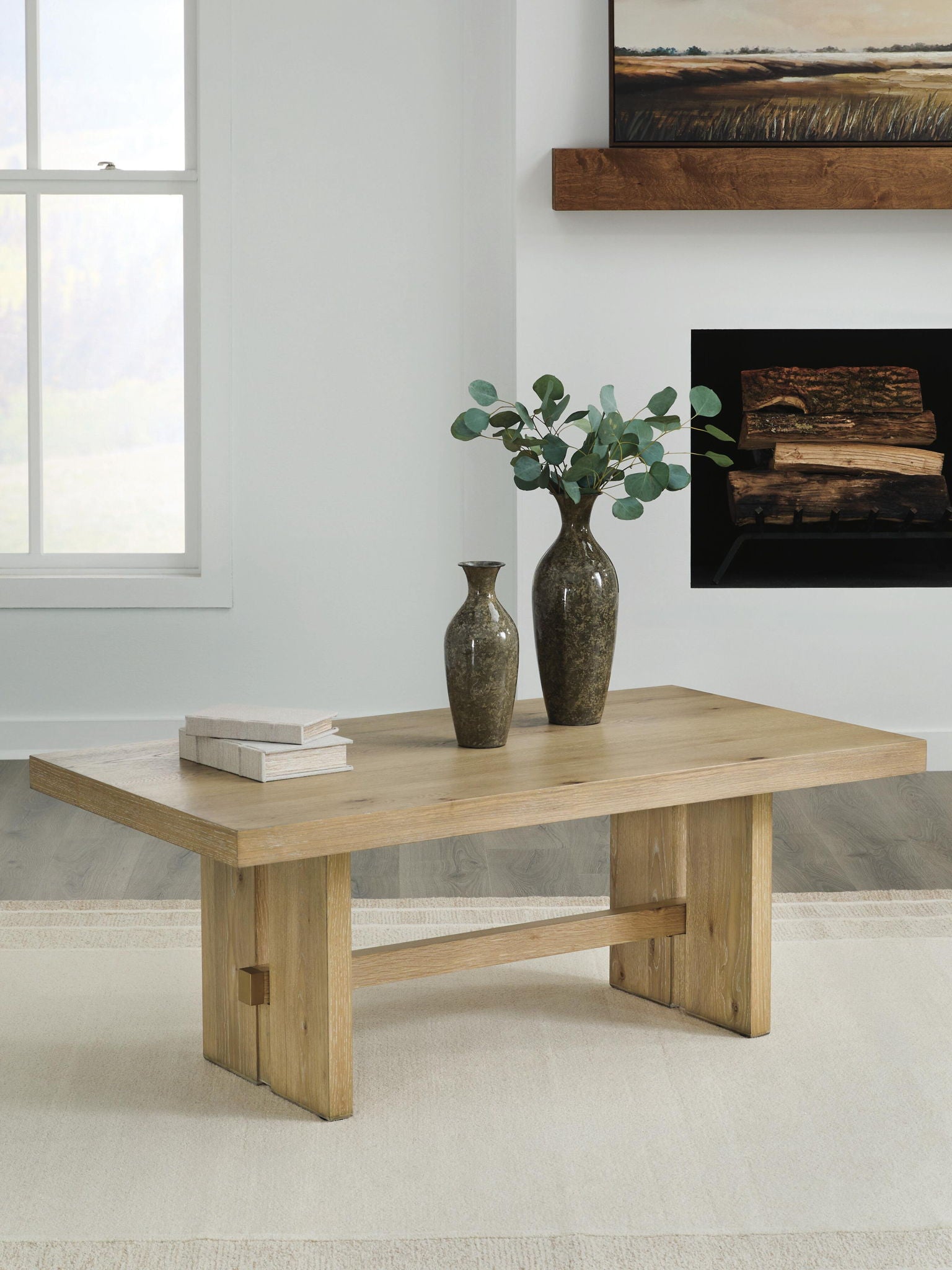 Light brown wood table with open shelf and sturdy legs in a living space
