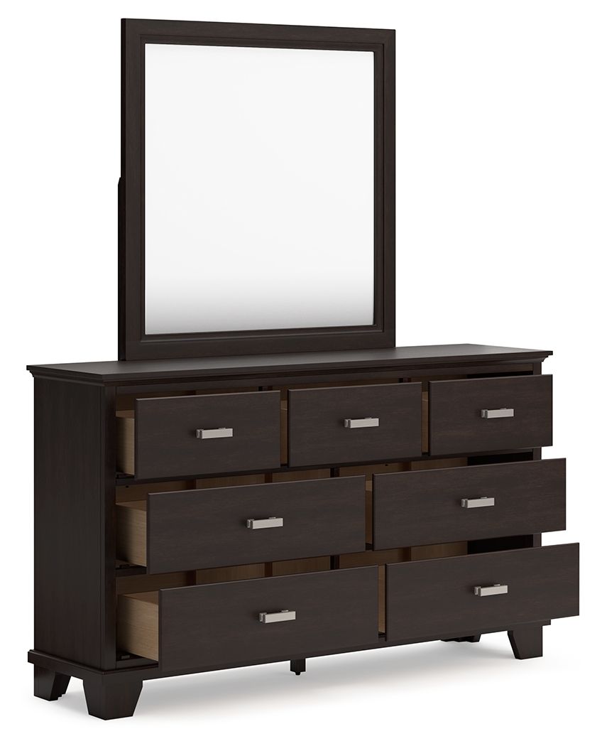 Dark brown dresser with mirror and stacked drawers, silver bar pulls on front.