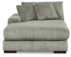 Corner chaise backrest and seat in fog-gray ribbed fabric with two accent pillows