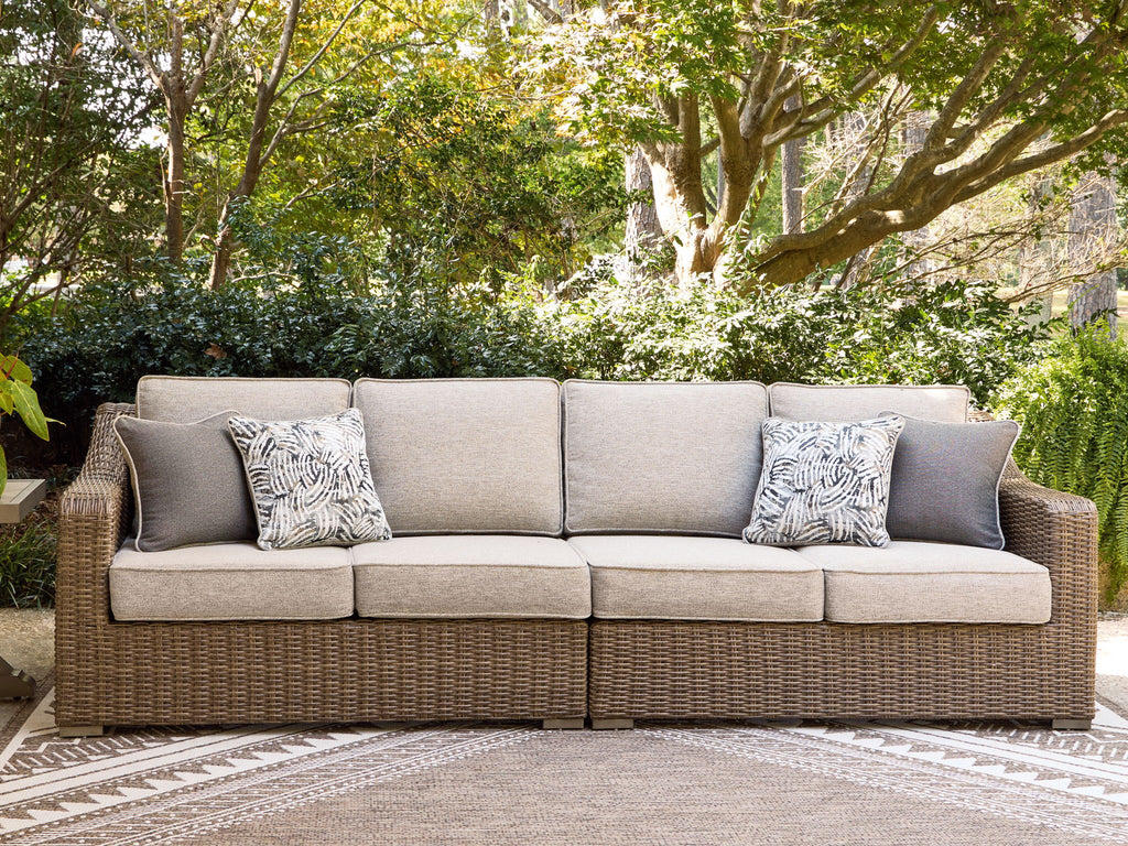 Beige outdoor loveseat set with bench cushions and two patterned accent pillows