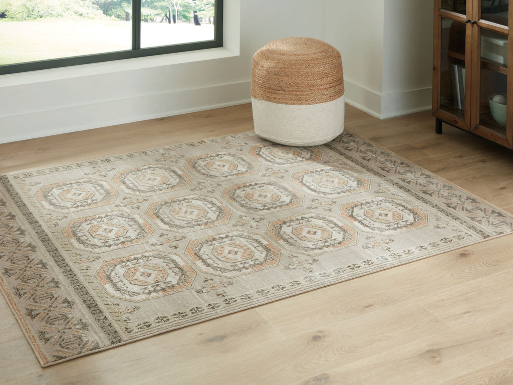 Beige rug with medallion motifs and decorative border on flat weave