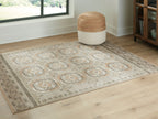 Beige rug with medallion motifs and decorative border on flat weave