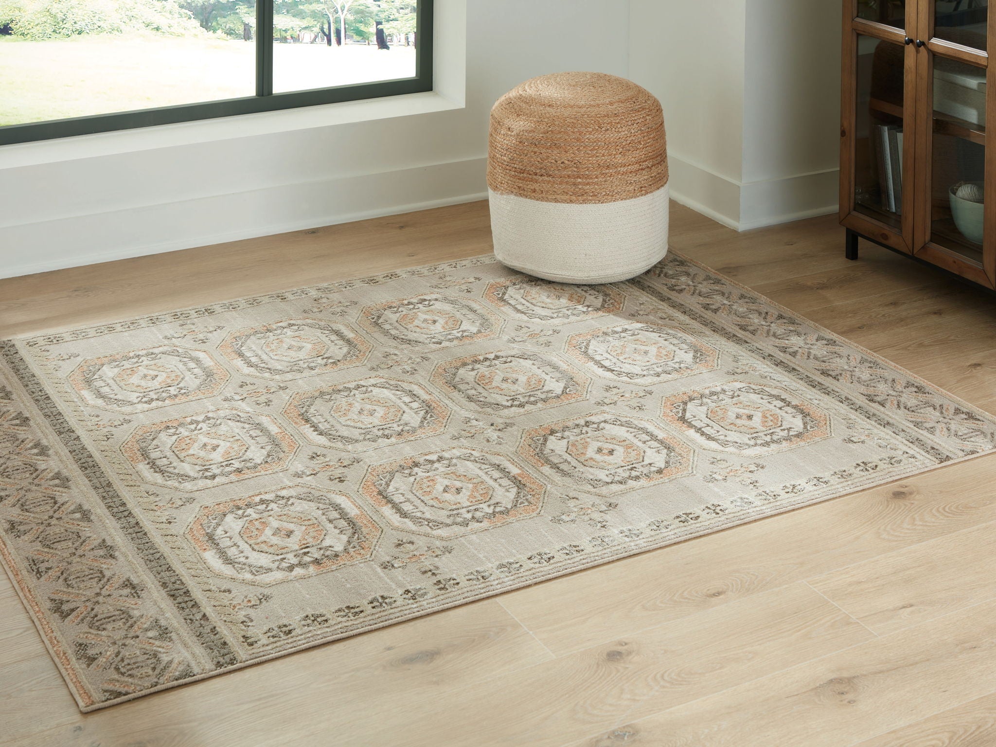 Beige rug with medallion motifs and decorative border on flat weave
