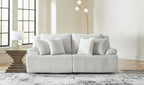 Light gray reclining sectional sofa with chaise and striped throw pillows