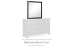 Brown rectangular bedroom mirror with slim frame, shown above a white dresser