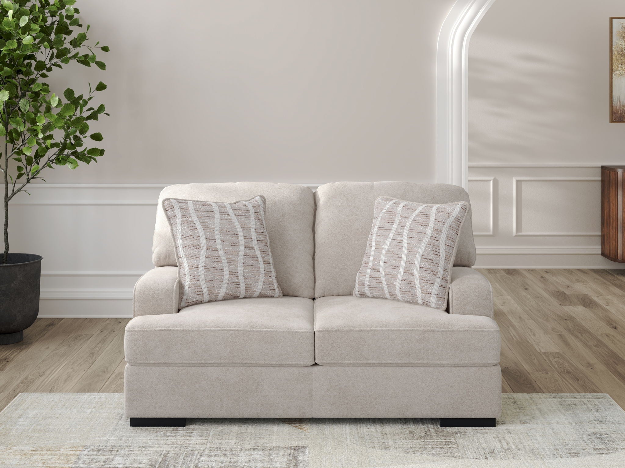 Taupe loveseat with two back cushions and two striped throw pillows, wide track arms