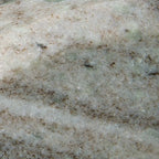 Taupe-gray stone surface with speckled texture and faint horizontal veining.