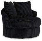 Swivel chair with ribbed dark upholstery, rolled arms, and two back cushions