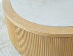 Round cocktail table with ribbed light brown wood base and white stone-look top
