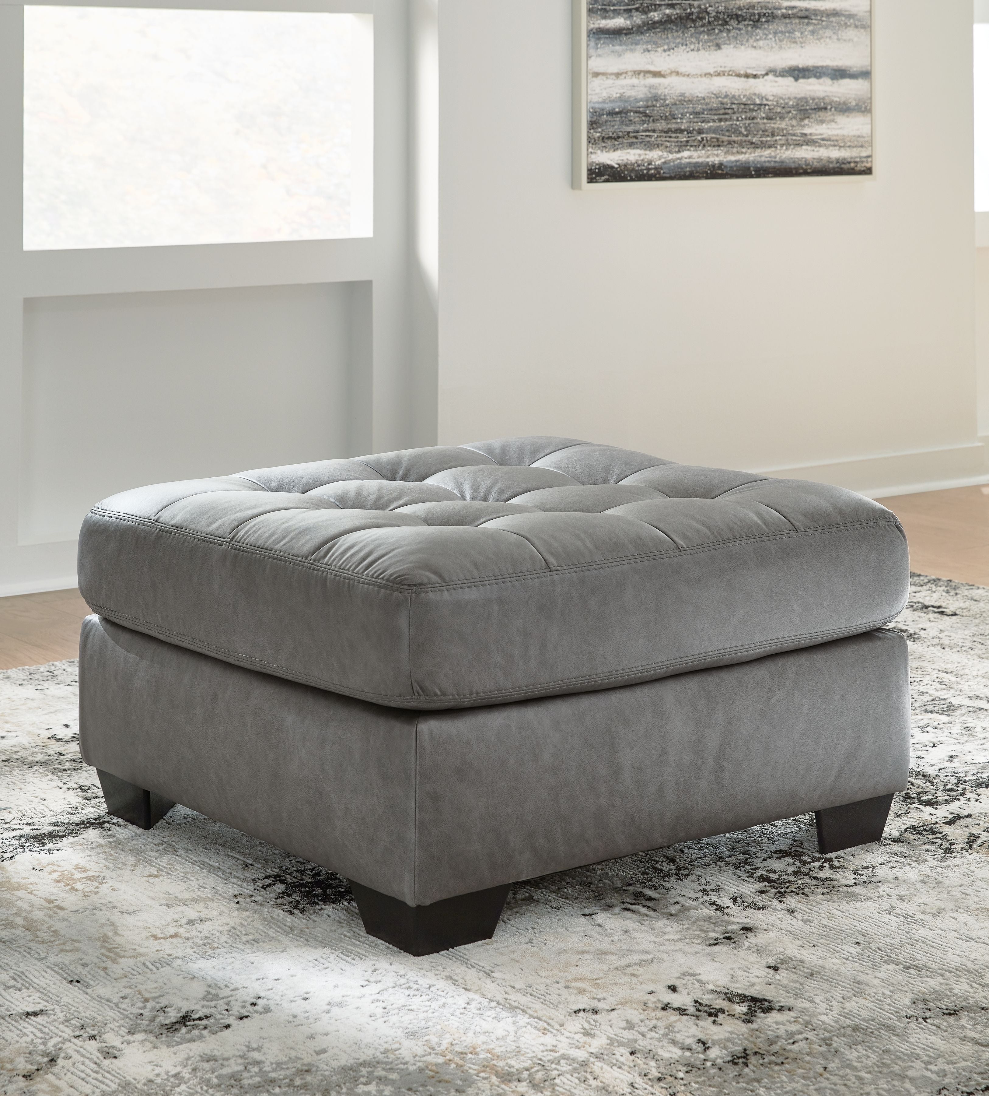Oversized accent ottoman, gray fabric with tufted seat and low black legs
