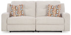 Stone 2-seat reclining sofa with two seat sections and geometric pattern pillows