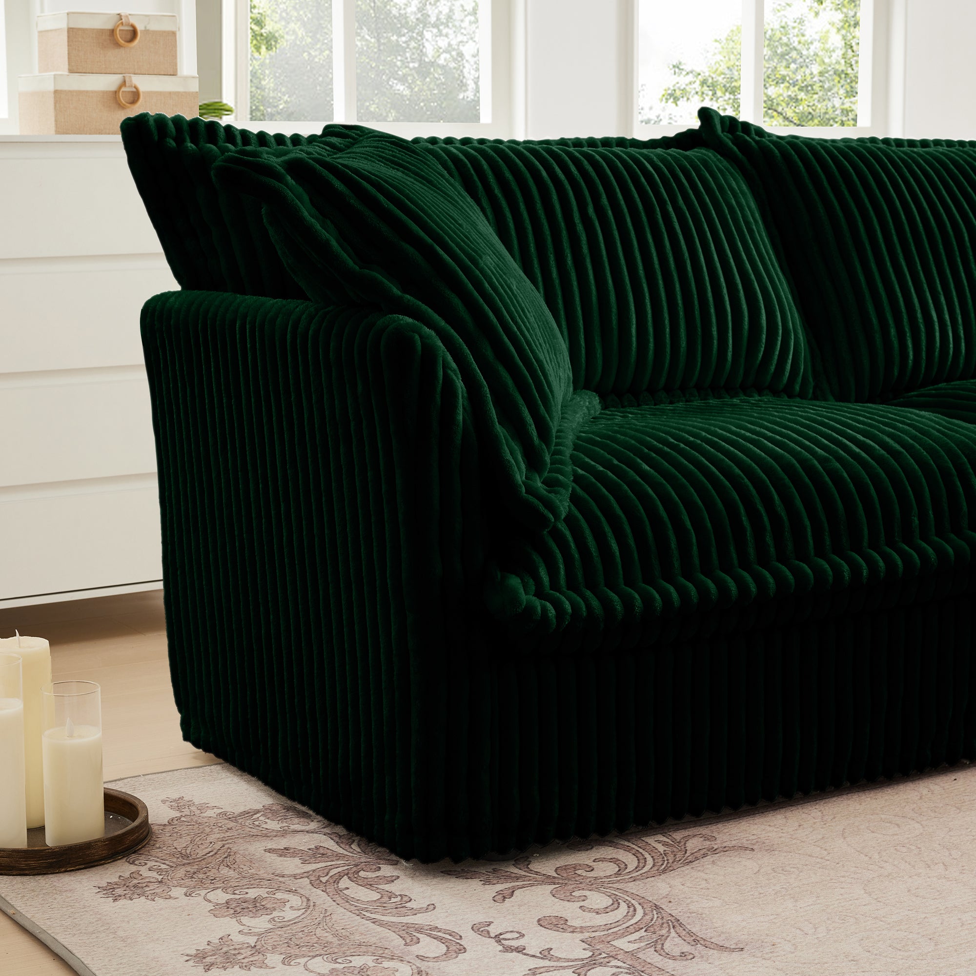 Green corduroy sectional sofa with chaise-style extension and thick padded armrest