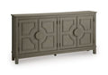 Warm gray accent cabinet with four carved door panels and bar handles