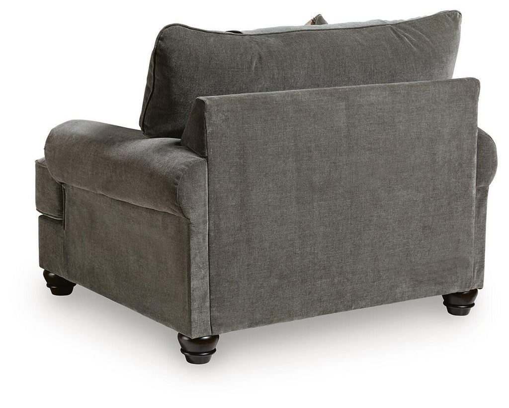Gray chair-and-a-half with square arms, rolled cushions, and back throw pillow