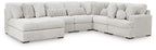 Light gray sectional sofa with curved corner seating and round accent pillows