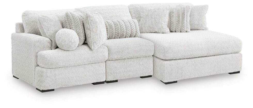 Light gray sectional sofa with chaise-style side and round accent pillows