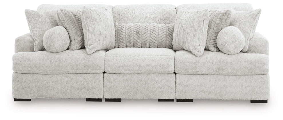 Light gray sectional sofa with multiple seat sections and round back pillows