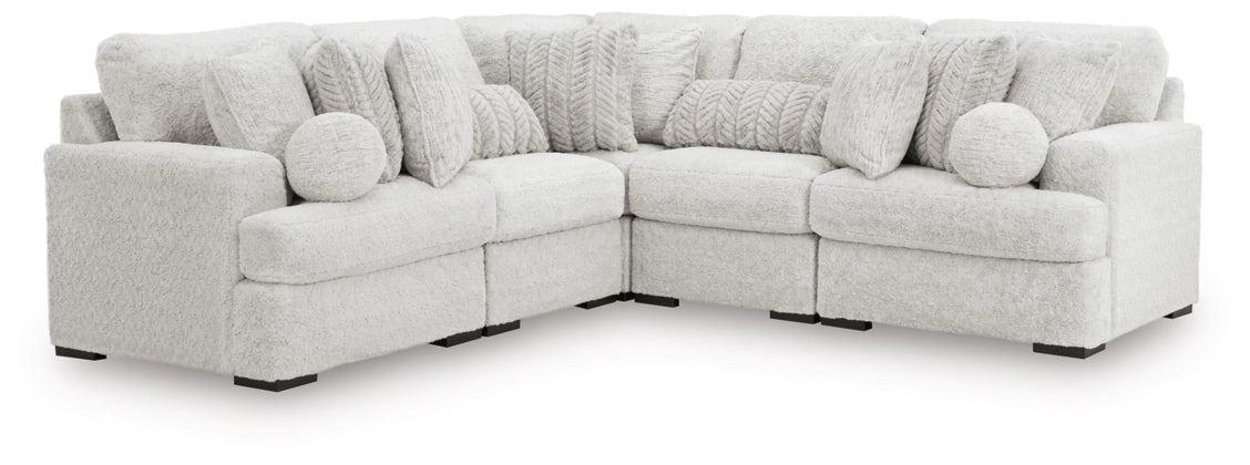 Light gray sectional sofa with corner chaise and textured throw pillows