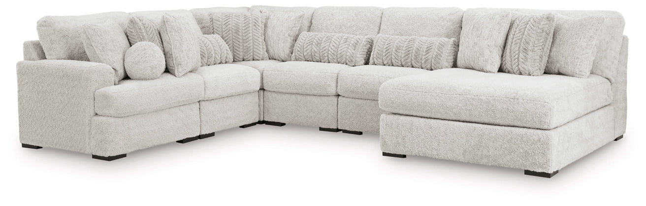 Light gray sectional sofa with corner chaise and stacked textured back cushions