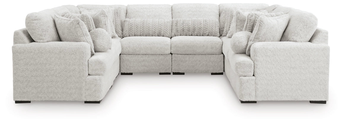 Light gray sectional sofa with wide corner and round accent pillows