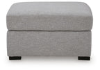 Pewter gray upholstered ottoman with cushioned lid and black feet, front view