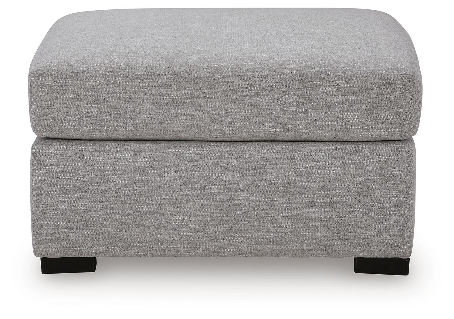 Pewter gray upholstered ottoman with cushioned lid and black feet, front view