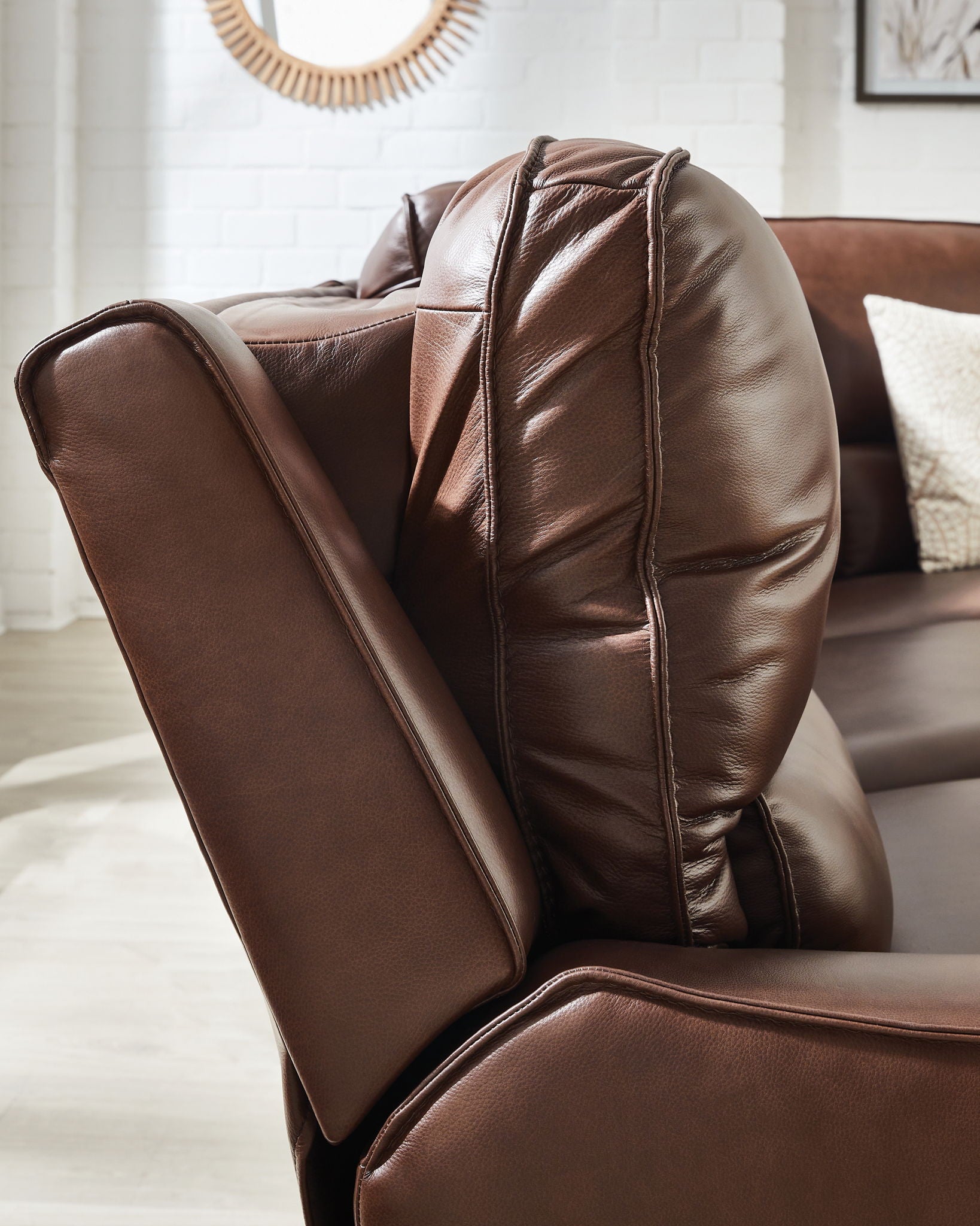 Corner power recliner with dark brown faux leather upholstery and tall armrest