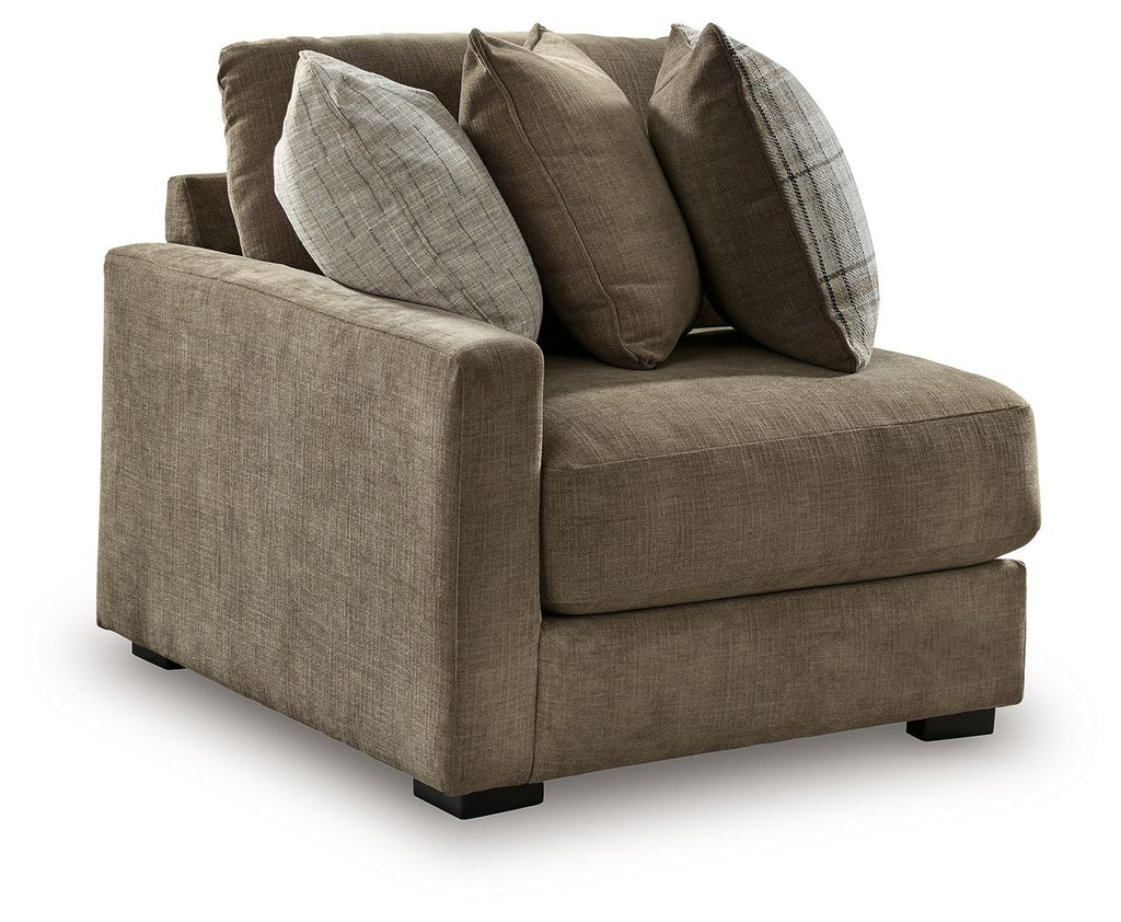 Upholstered corner chair with rolled arms, taupe fabric and four decorative pillows