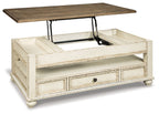 Lift-top cocktail table with raised top, dark wood surface, white base and drawer.