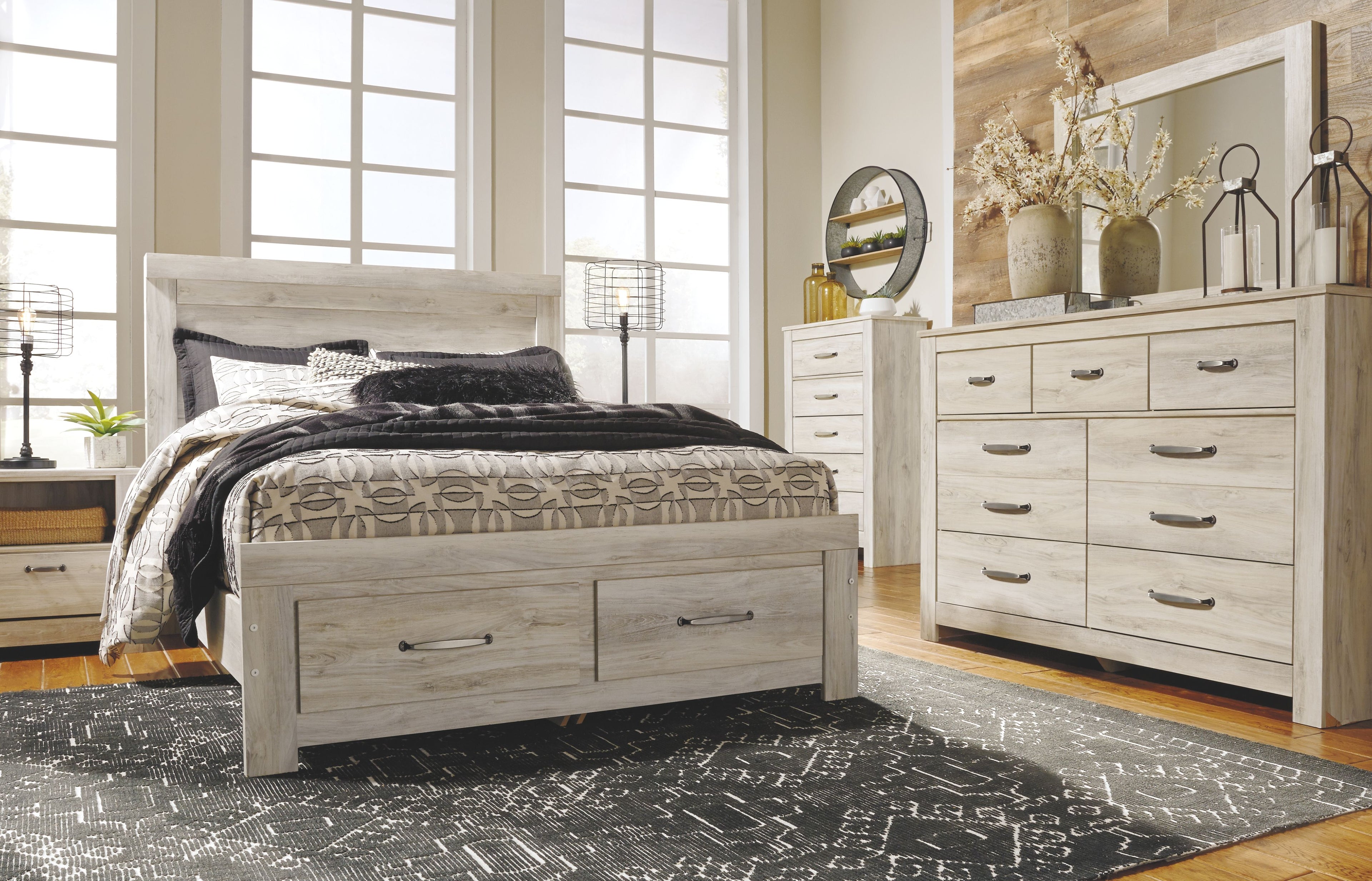 Bellaby beige panel headboard with bed base storage drawers and patterned quilt
