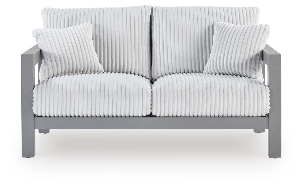 Gray loveseat with ribbed striped cushion and two matching throw pillows