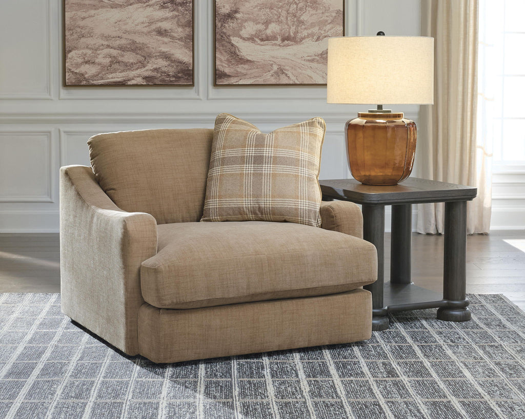 Chair and a half armchair with tan upholstery and square plaid back pillow