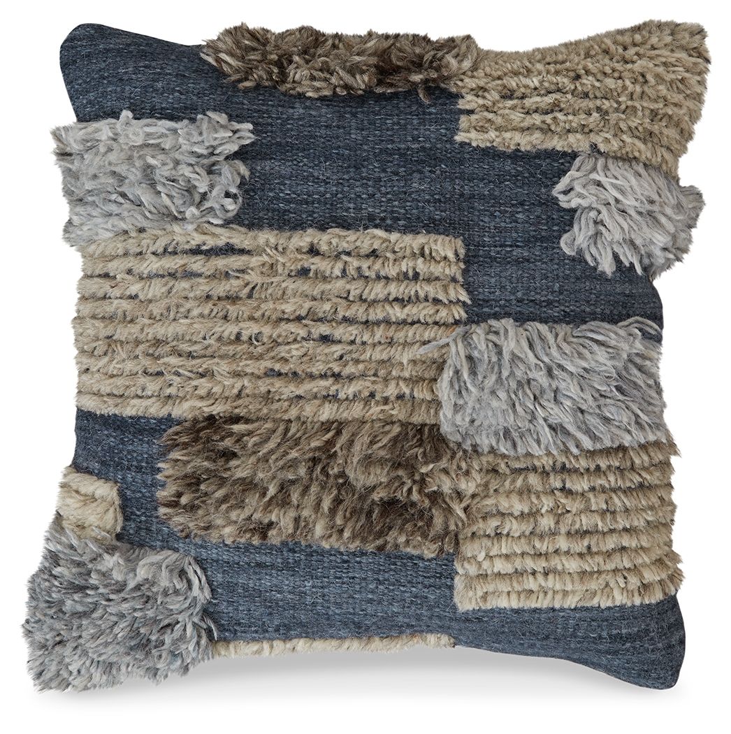 Patchwork throw pillow with dark blue, tan, and gray panels plus chunky fringe