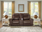 Dark brown power reclining loveseat with central console and adjustable headrests, cushioned back.