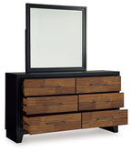 Brown wood dresser with black sides, mirror and six drawers with silver pulls