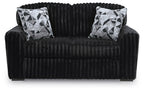 Black corduroy loveseat with two black-and-white geometric throw pillows