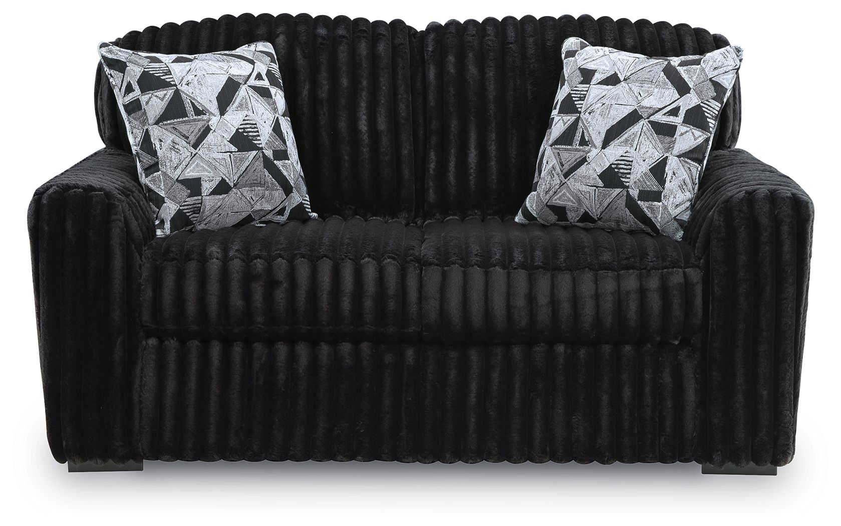 Black corduroy loveseat with two black-and-white geometric throw pillows