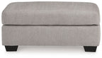 Light gray flannel ottoman with dark legs and smooth rounded sides