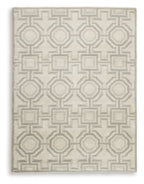 Beige rug with dense geometric motif pattern in light gray, square close-up