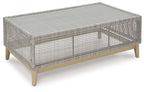 Gray rectangular cocktail table with woven lattice top and tapered wooden legs