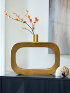 Gold vase holding orange blossoms, with wide oval cutout and neck