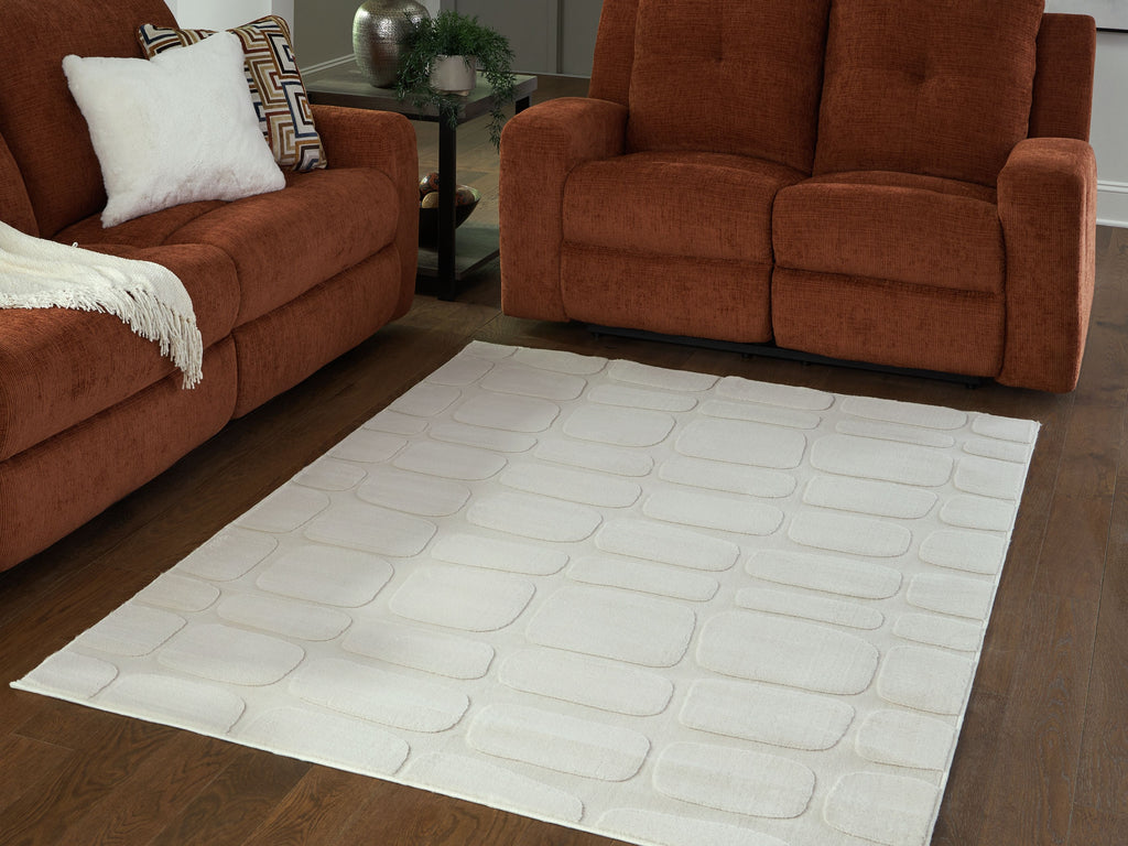 Washable beige rug in living room with embossed stone-look pattern