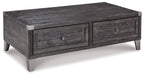 Dark gray lift-top cocktail table with two drawers and metal corner brackets