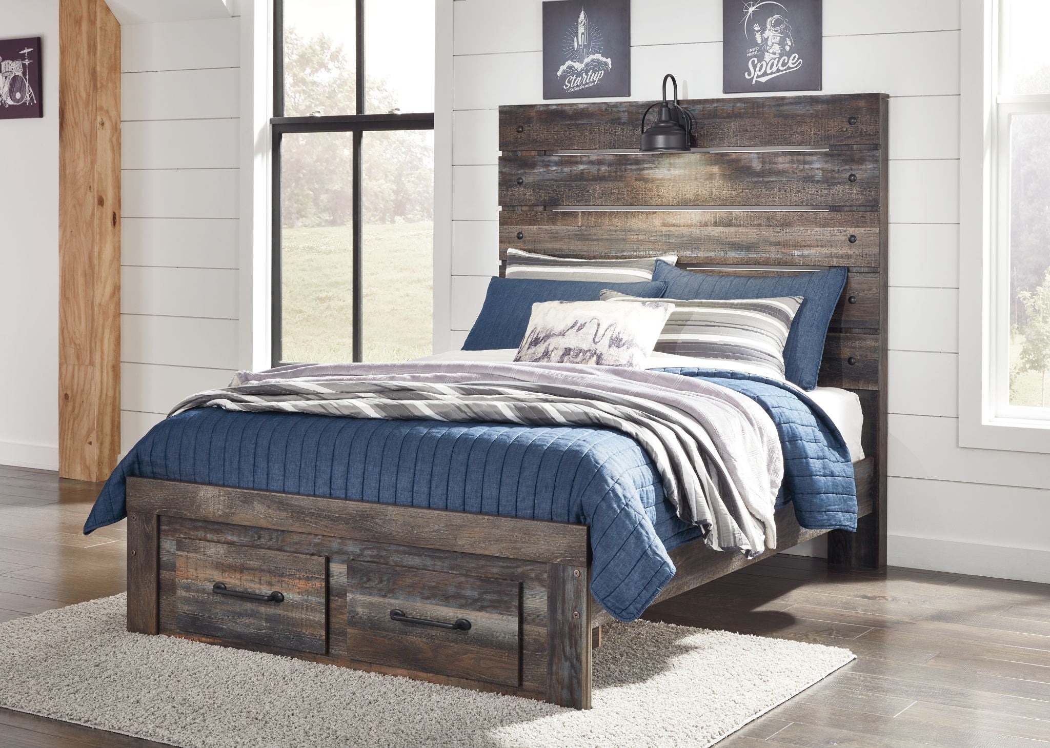 Panel bed with dark distressed wood frame, slat headboard, and blue bedding