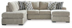 Beige corner chaise sectional sofa with patterned pillows and two matching storage ottomans