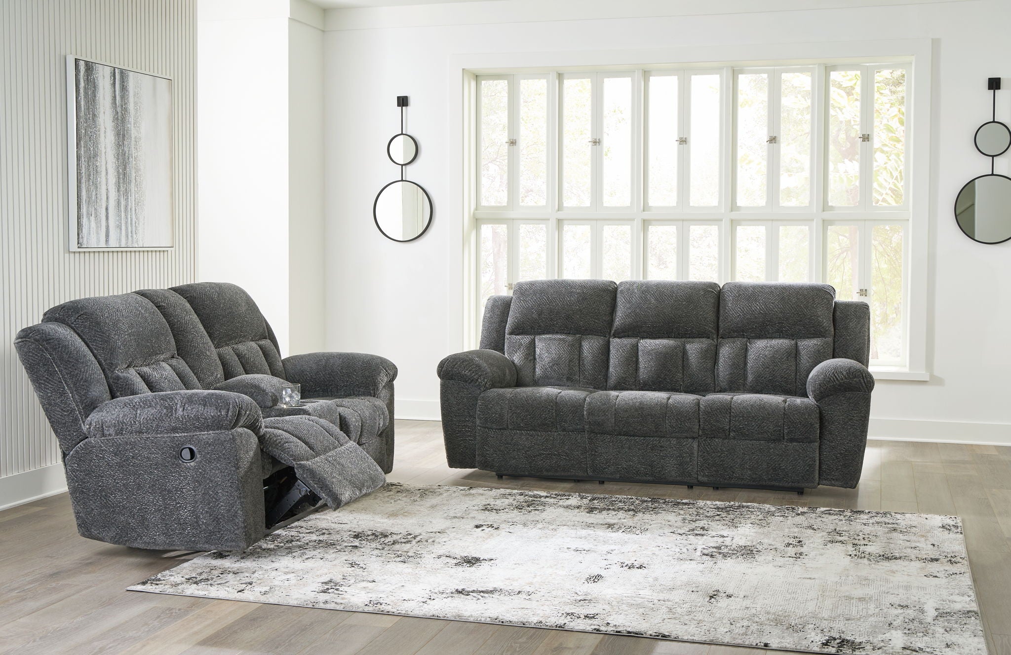Reclining living room set with dark gray recliner sofa and matching recliner loveseat