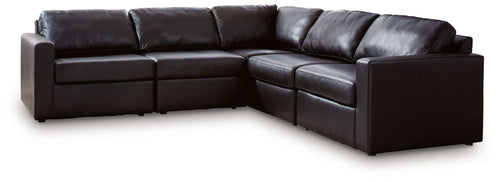 Black sectional sofa with chaise corner and tufted back cushions