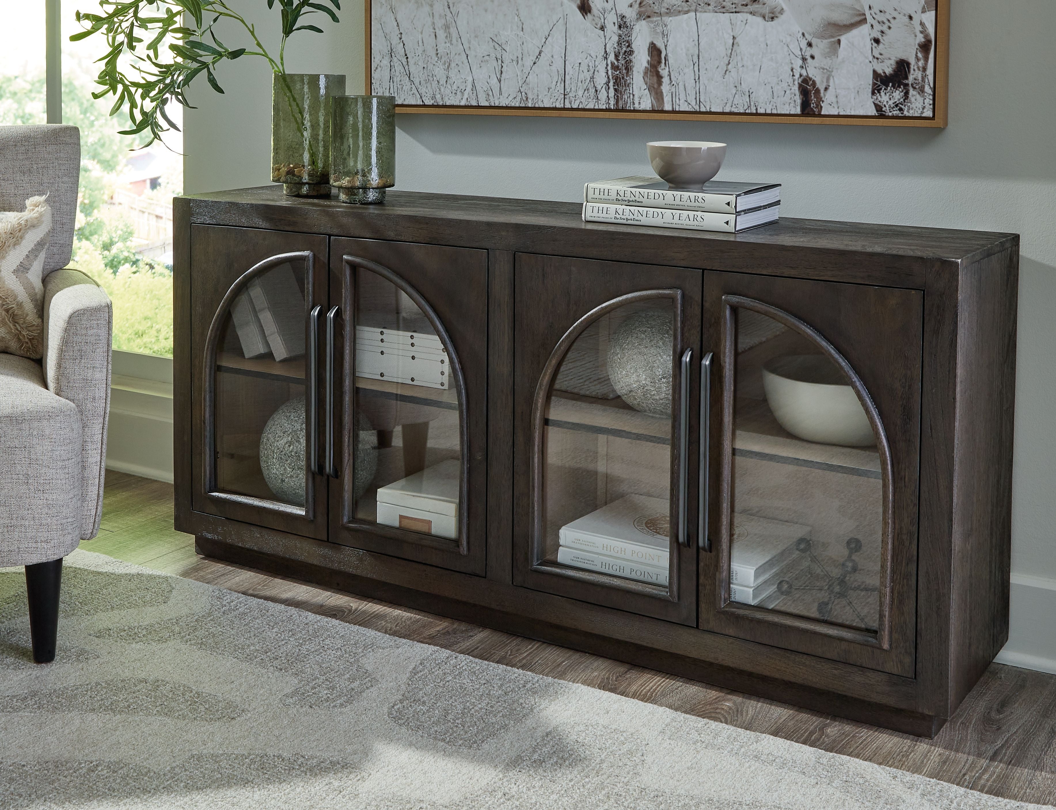 Grayish brown accent cabinet with four arched glass doors and central handles