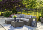 Gray sectional with ottomans, coffee table, and striped throw pillows
