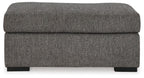 Pewter fabric ottoman with thick, rounded back panel and low black legs